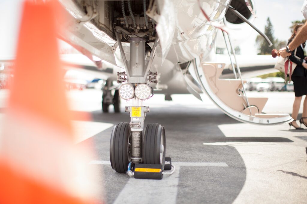Female businesswoman leaving private jet at airport